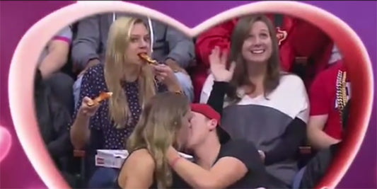 This Woman Double-Fisting Pizza On The Jumbotron Is Our Newest National Treasure